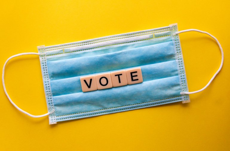 A mask with blocks that spell out vote 