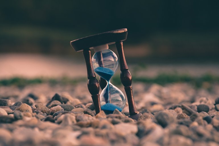 Sand comes out of an hour glass